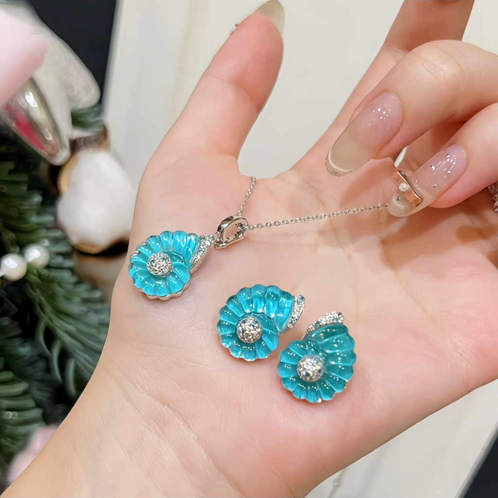 Rhodium-plated sterling silver nautilus shell stud earrings with blue cubic zirconia and clear pavé accents