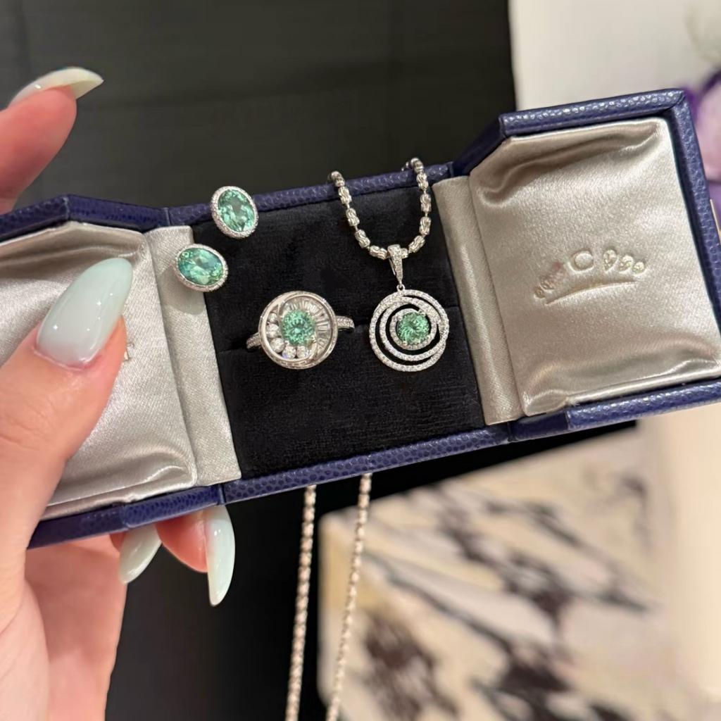 925 sterling silver oval synthetic YAG stud earrings in Paraiba blue and mint green with cubic zirconia halo surrounds and butterfly backs
