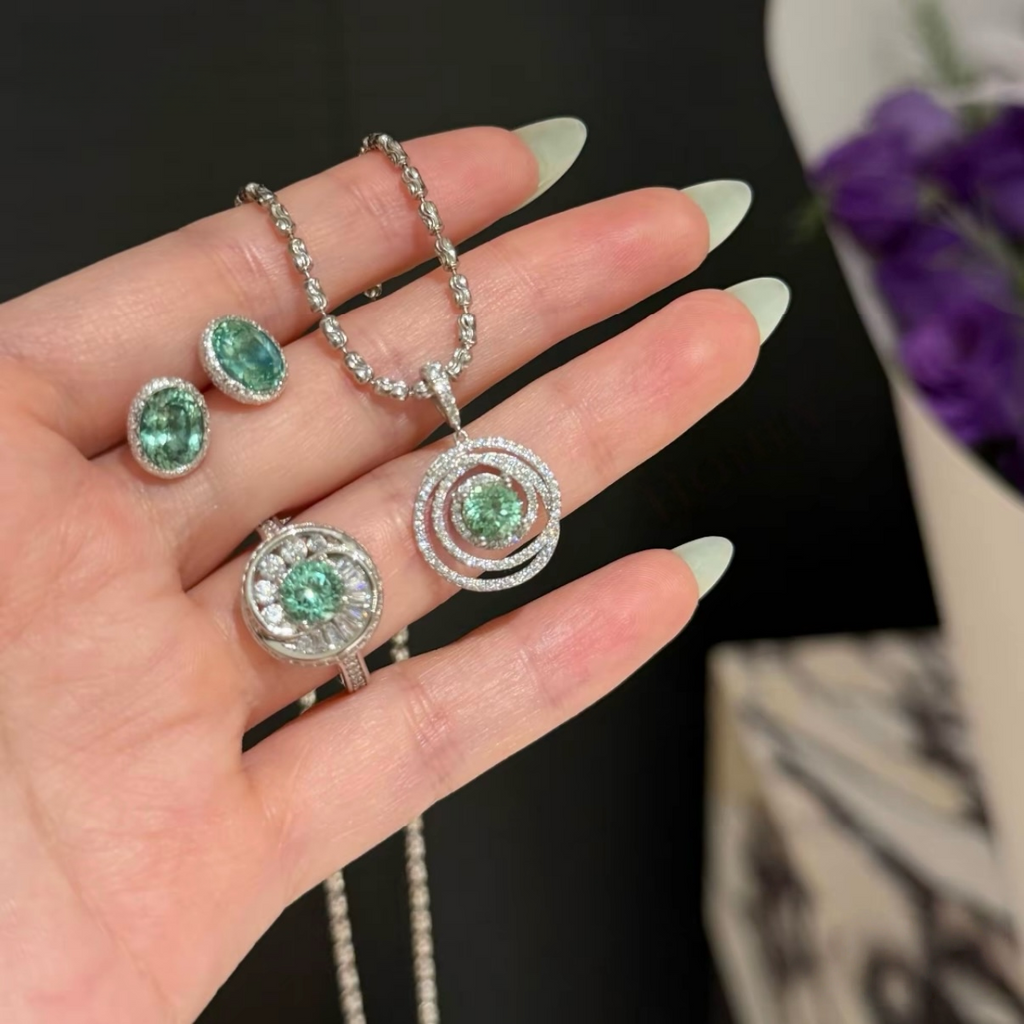 925 sterling silver oval synthetic YAG stud earrings in Paraiba blue and mint green with cubic zirconia halo surrounds and butterfly backs