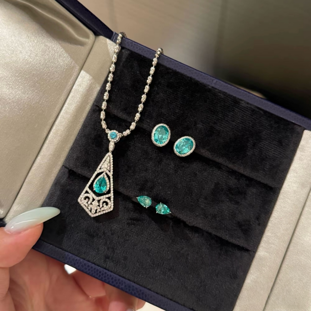 925 sterling silver oval synthetic YAG stud earrings in Paraiba blue and mint green with cubic zirconia halo surrounds and butterfly backs