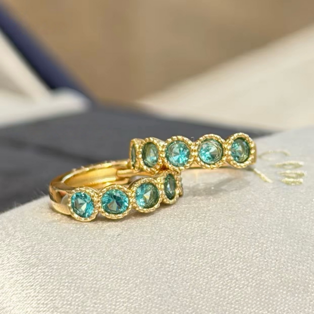 18K gold-plated sterling silver huggie earrings with round aqua cubic zirconia and beaded bezel-style frames