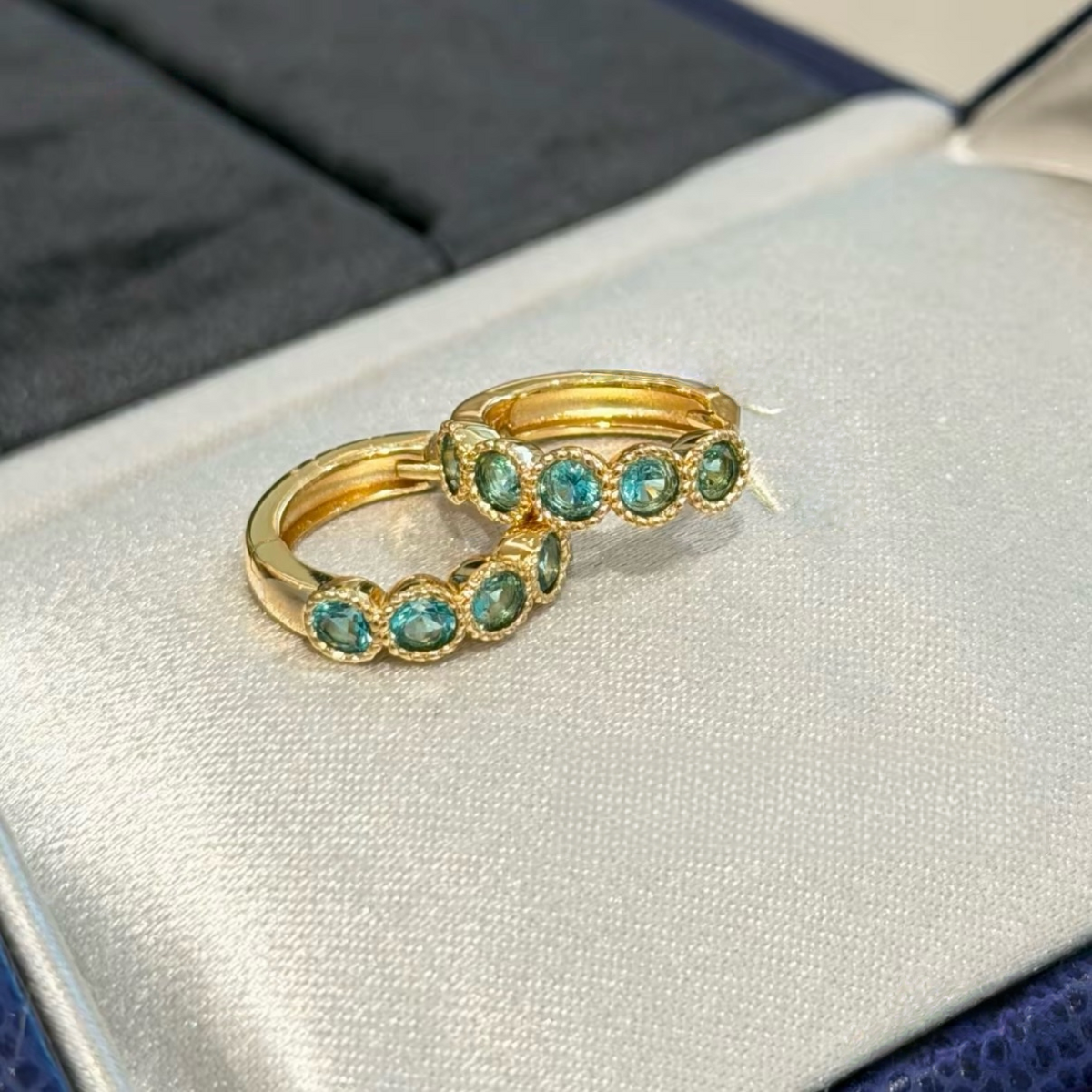 18K gold-plated sterling silver huggie earrings with round aqua cubic zirconia and beaded bezel-style frames