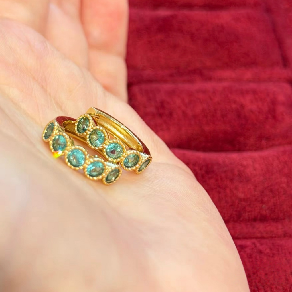 18K gold-plated sterling silver huggie earrings with round aqua cubic zirconia and beaded bezel-style frames