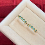 18K gold-plated sterling silver huggie earrings with round aqua cubic zirconia and beaded bezel-style frames