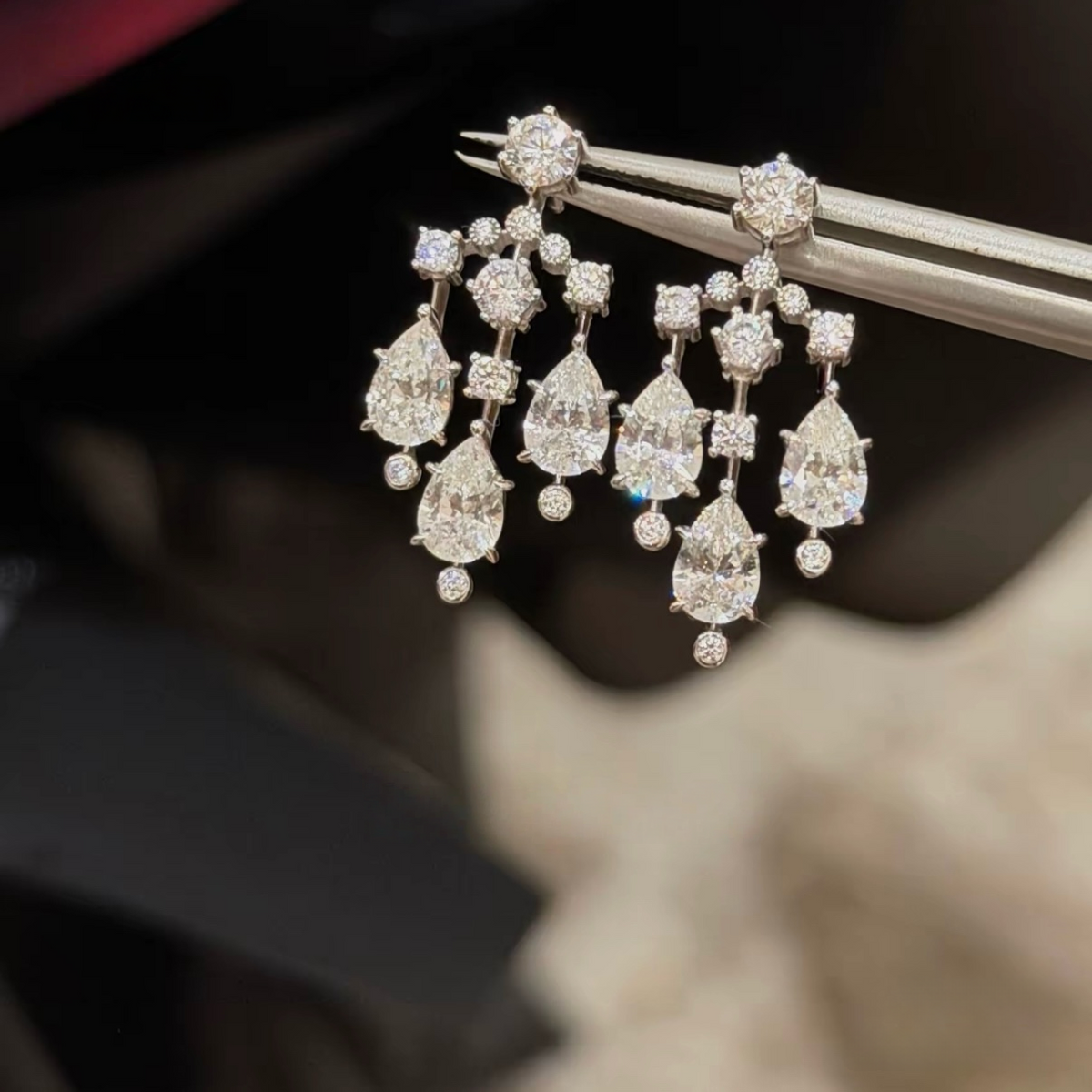Sterling silver chandelier-style drop earrings with pear-cut and round cubic zirconia