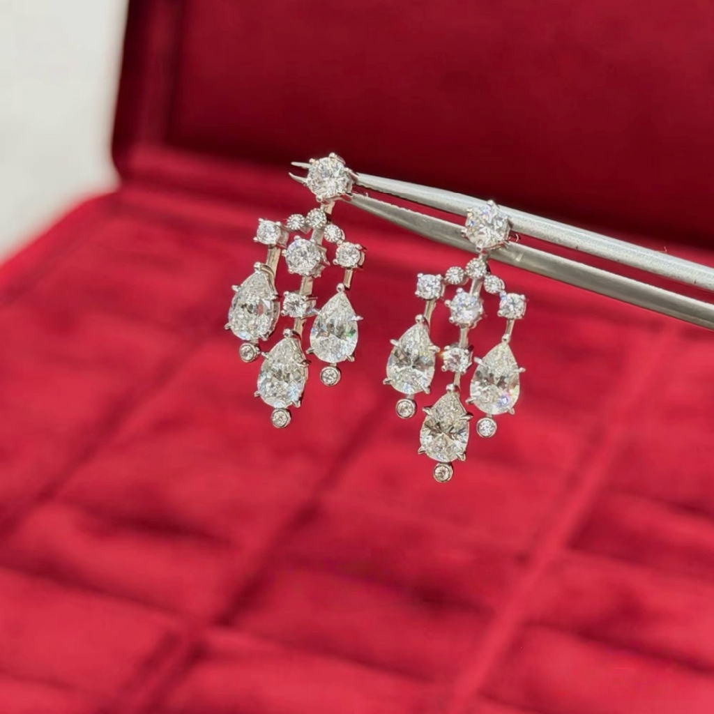 Sterling silver chandelier-style drop earrings with pear-cut and round cubic zirconia