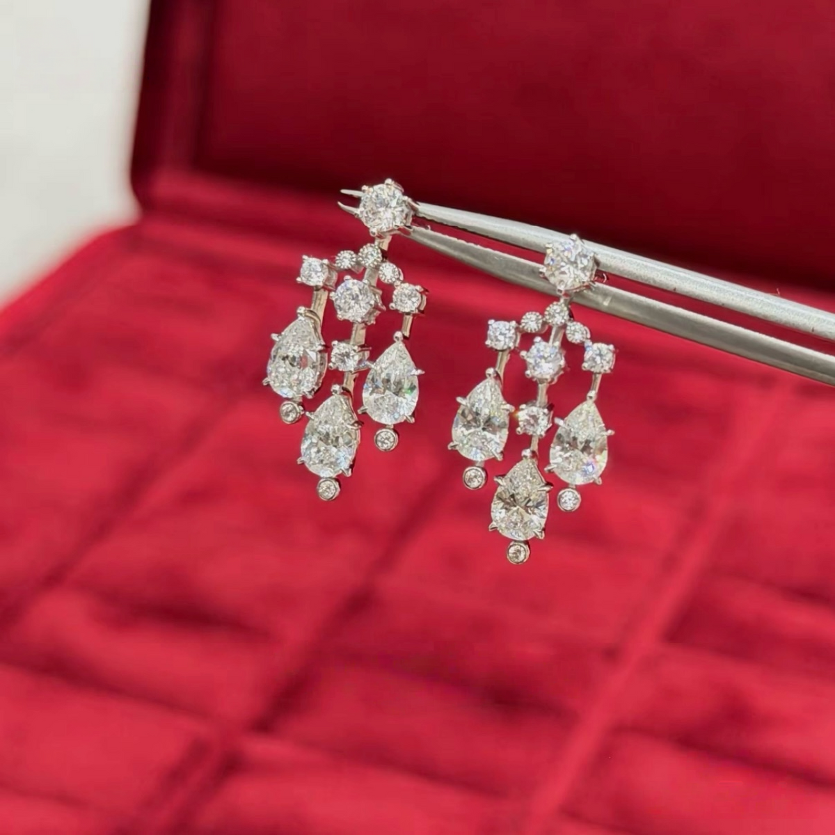 Sterling silver chandelier-style drop earrings with pear-cut and round cubic zirconia