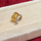 Two-tone sterling silver ear cuff with an 18K gold-plated quilted band and a cubic zirconia-set silver wave band