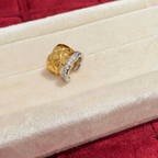 Two-tone sterling silver ear cuff with an 18K gold-plated quilted band and a cubic zirconia-set silver wave band