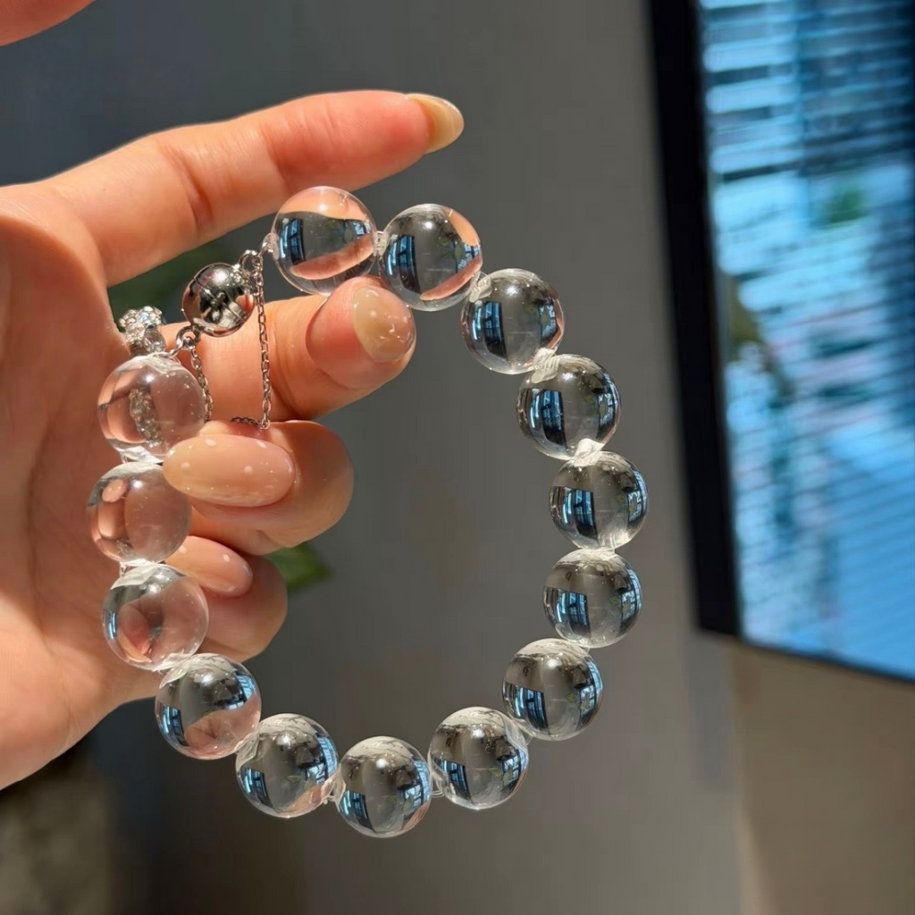 Natural rock crystal bracelet with 12–13 mm round beads, polished 925 sterling silver details, and a magnetic clasp