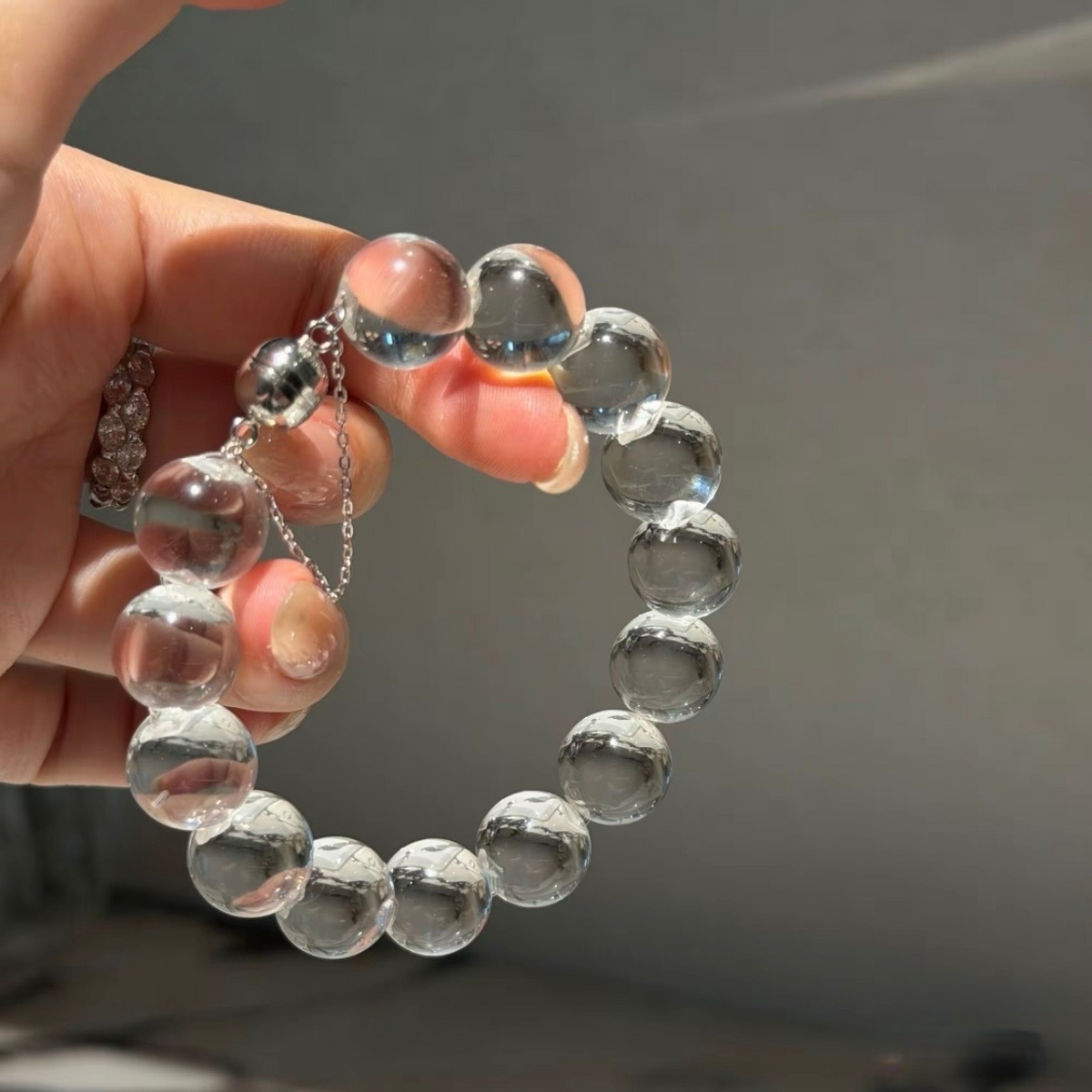 Natural rock crystal bracelet with 12–13 mm round beads, polished 925 sterling silver details, and a magnetic clasp