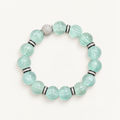 Pale mint-blue natural fluorite bracelet with carved pumpkin beads, transparent spacer elements, sterling silver decorative rings, and sparkling accent bead