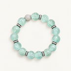 Pale mint-blue natural fluorite bracelet with carved pumpkin beads, transparent spacer elements, sterling silver decorative rings, and sparkling accent bead