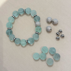 Pale mint-blue natural fluorite bracelet with carved pumpkin beads, transparent spacer elements, sterling silver decorative rings, and sparkling accent bead
