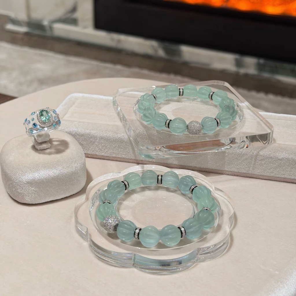 Pale mint-blue natural fluorite bracelet with carved pumpkin beads, transparent spacer elements, sterling silver decorative rings, and sparkling accent bead