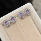 Sterling silver stud earrings with green and purple oval cubic zirconia center stones surrounded by clear sparkling halos