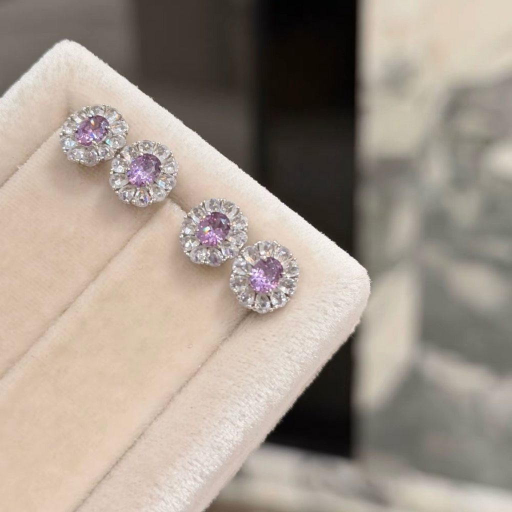 Sterling silver stud earrings with green and purple oval cubic zirconia center stones surrounded by clear sparkling halos